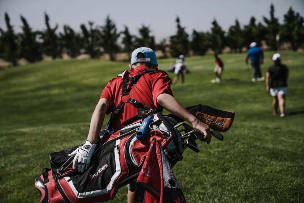 how to avoid injury blog featured image on golfer carrying a golf bag