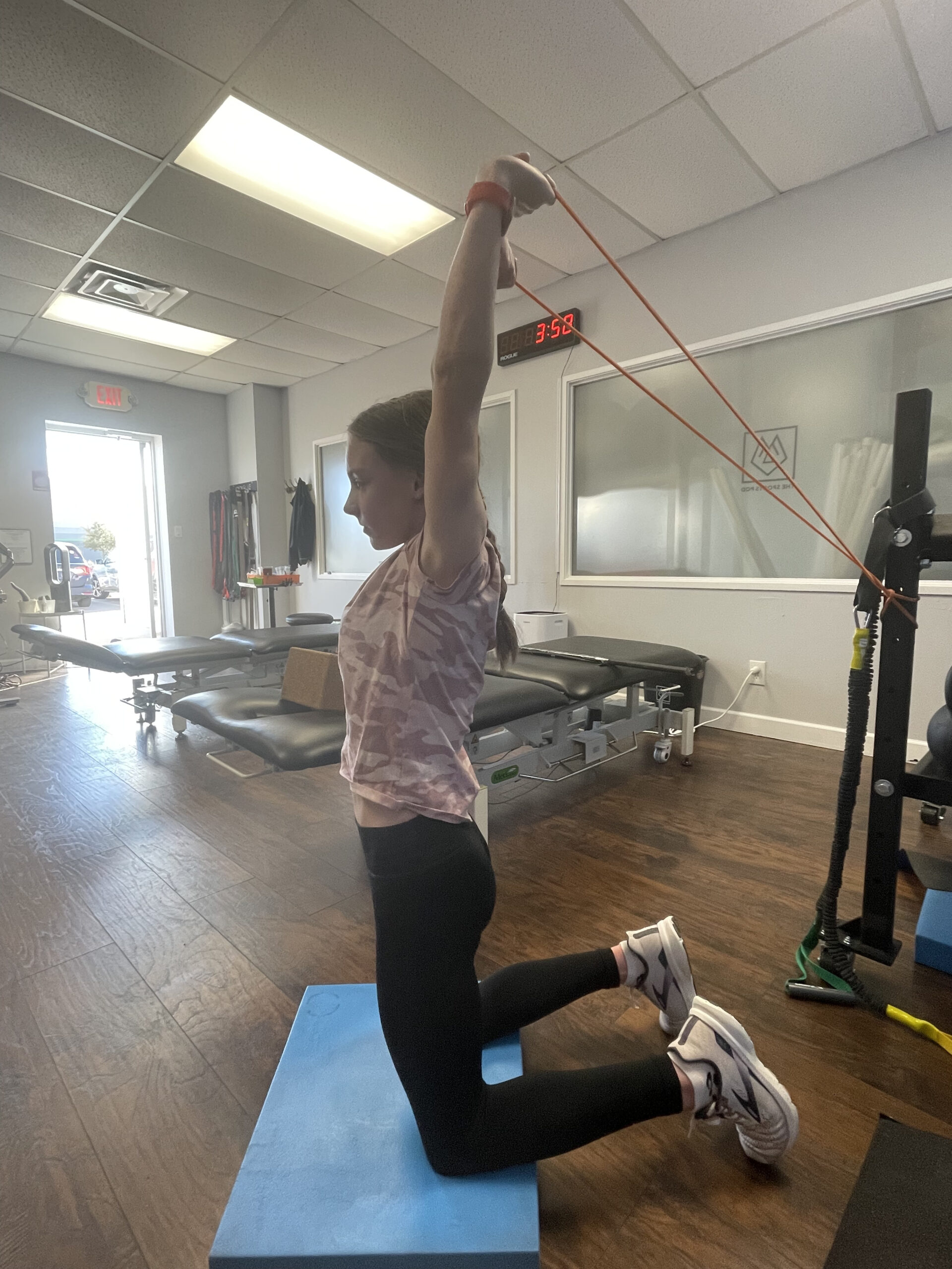 One of the biggest contributors of low back pain in our gymnasts, is lack of range of motion in the shoulders and the hips. In this photo, Madi is working on shoulder flexion, without low back extension. Head to our youtube for more like this! Give it a try!